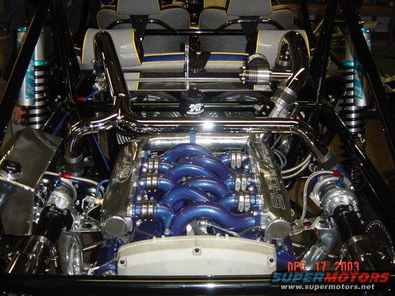 Custom engine bay with blue intake manifold, chrome piping, and twin turbos. Date stamp reads APR 17 2003