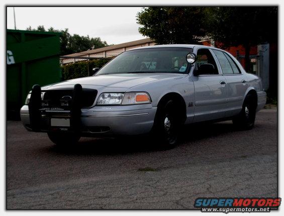 Silver 1998 Ford Crown Victoria police car with push bumper