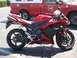 2007 Yamaha R1 - A red 2007 Yamaha R1 motorcycle is parked in front of a red service truck.