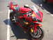 2007 Yamaha R1 - A red Yamaha R1 motorcycle is parked on a paved surface with a white line visible.