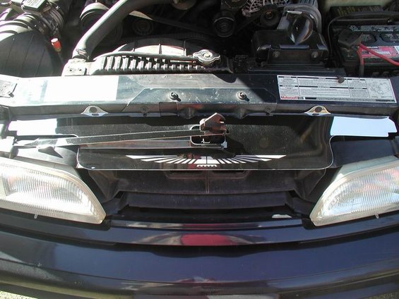 1990 Ford Thunderbird front grille with emblem and engine bay visible