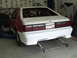 1990 Ford Mustang - Rear view of a 1990 Ford Mustang with a roll cage and custom bumper, modified for racing.