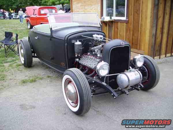Black hot rod roadster with exposed engine and chrome fuel tank