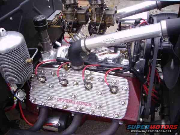 Close-up of a V8 engine with Offenhauser valve covers and dual carburetors