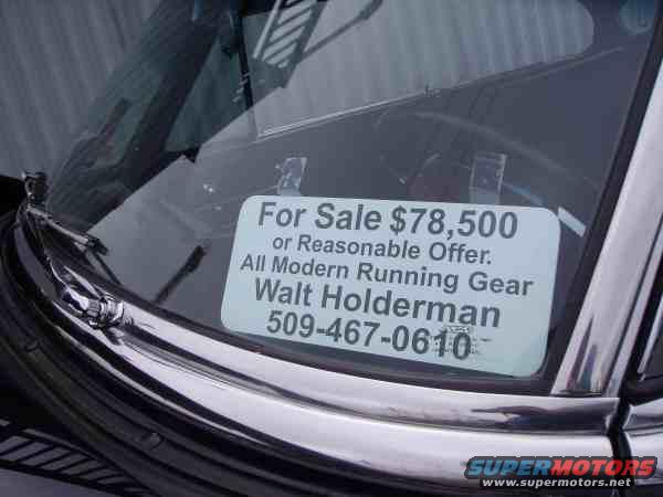 Windshield of a car with a 'For Sale $78,500' sign, including contact info