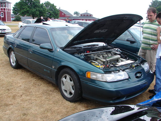 1993 Ford Taurus SHO, green sedan with hood open, front 3/4 view