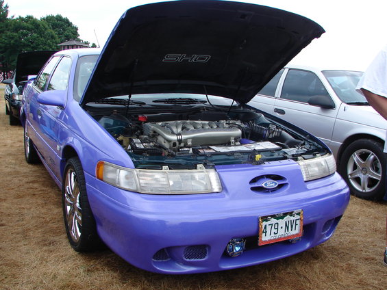 Purple 1993 Ford Taurus SHO, front view, hood open showing engine. License plate 479-NVF