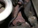 1987 Lincoln Town Car - Close-up of exhaust manifold and hoses, likely from an older vehicle.
