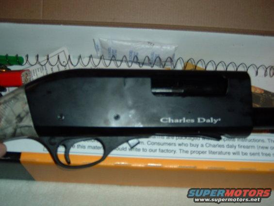 Charles Daly shotgun receiver with visible text and a coiled spring