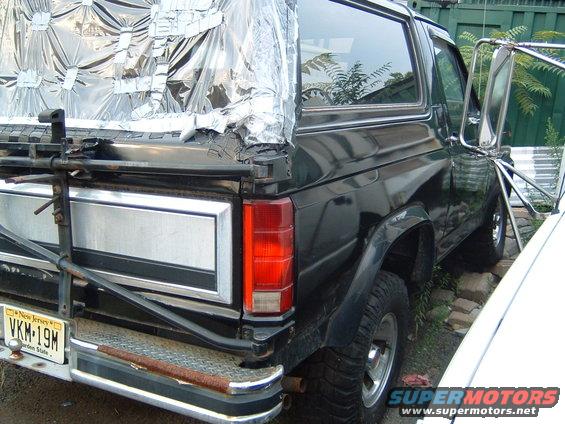 Rear of a dark green Ford Bronco with a silver tailgate panel and a New Jersey license plate
