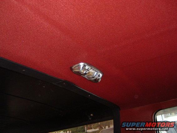 Red headliner with chrome interior light fixture and black trim