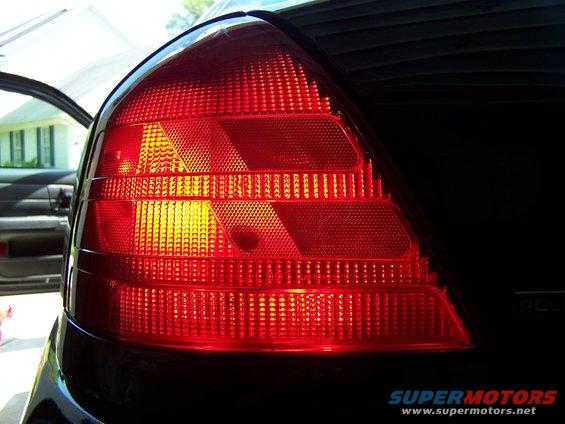 Close-up of a red car taillight with a textured lens
