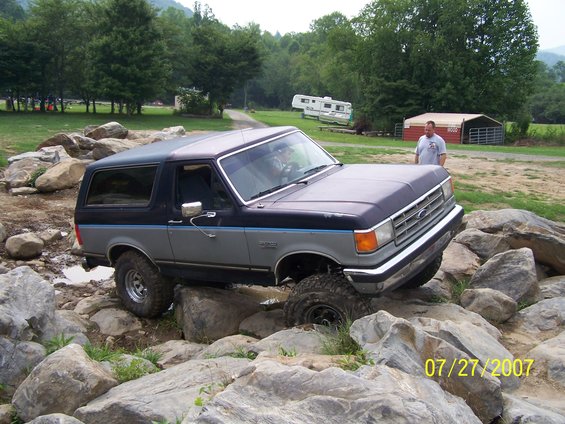 1987 Ford Bronco navigating a rocky obstacle course