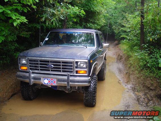 Dark blue 1980 Ford Bronco on muddy trail