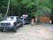1992 Ford Mustang - Ford F-250 Super Duty and a classic Ford Bronco on a trailer at a wooded cabin site.