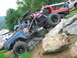 1992 Ford Mustang - Custom off-road buggy navigates a rocky incline, with other trucks visible in the background.