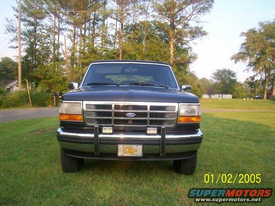 Front view of a dark blue Ford Bronco parked on grass. Has a Georgia Tech license plate