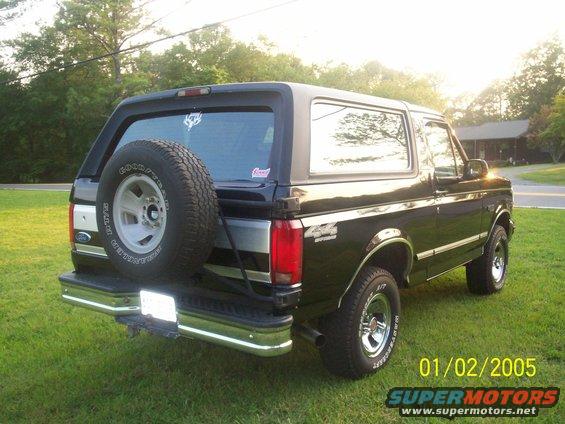 Black 1993 Ford Bronco with a spare tire mounted on the rear, parked on grass