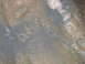 1992 Ford Mustang - The image shows a muddy ground with rocks and debris, appearing wet and dark, with no discernible vehicle present.