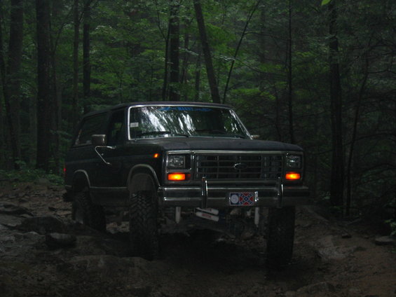 Ford Bronco on a dirt trail in the woods