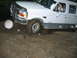 1992 Ford Mustang - A white Ford F-Series truck is shown off-roading over rocks and mud.