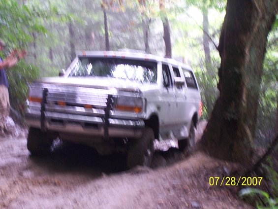 White SUV with a brush guard on a dirt path, 1992 model year