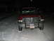 1996 Dodge 2500 - A red Dodge pickup truck sits in the snow at night, its front grille and headlights illuminated.