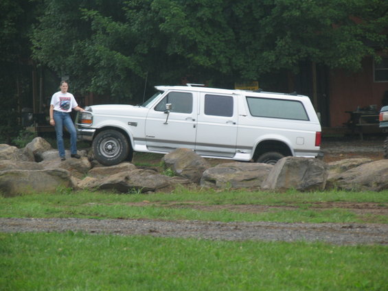 1995 Ford C-350 (Centurion Conversions) extended SUV parked on rocks with a person standing next to it