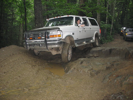 1995 Ford C-350 (Centurion Conversions) navigating a difficult off-road course with mud and rocks
