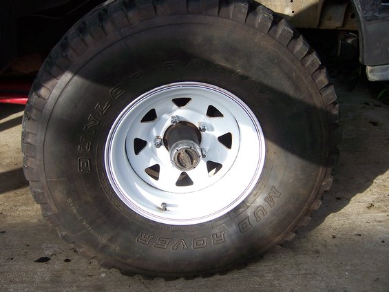 Close-up of a Dunlop Mud Rover tire on a white 5-lug wheel