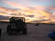 2002 Jeep Wrangler - Two vehicles on a sandy beach during a colorful sunset.