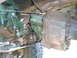 1994 Ford F-250 - Close-up view of the drivetrain components, including the transfer case and differential, with visible rust and green paint.