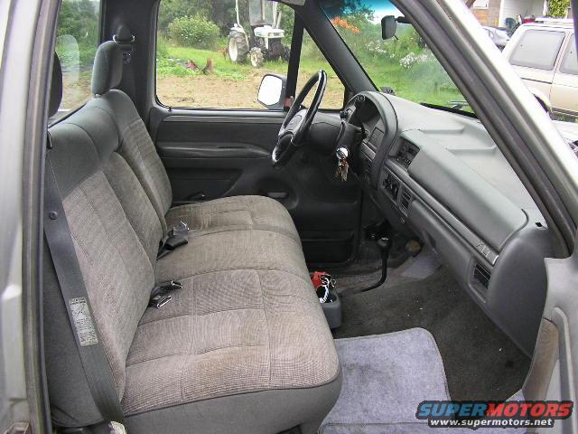Gray interior of a 1994 Ford F-150 pickup truck with bench seat and dashboard