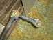 2005 Ford Excursion - A close-up view of a vehicle's suspension part, possibly a tie rod end, against a textured background.