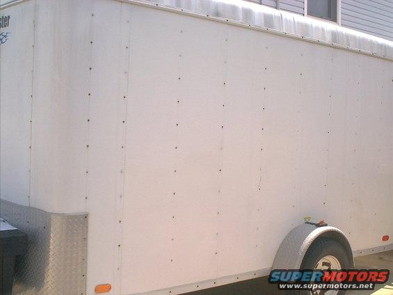 White cargo trailer side with diamond plate corner and fender