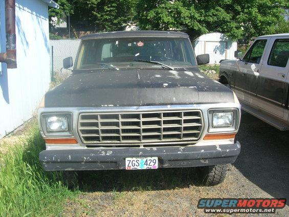 Front view of a dark SUV with a large grille and license plate ZGS 429
