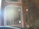 1978 Ford Bronco - The dashboard's center console shows exposed wiring and empty slots where components were removed.