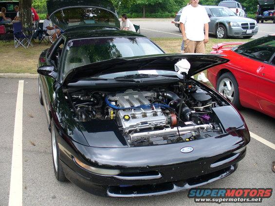 1991 Ford Probe with hood open, parked next to a red car