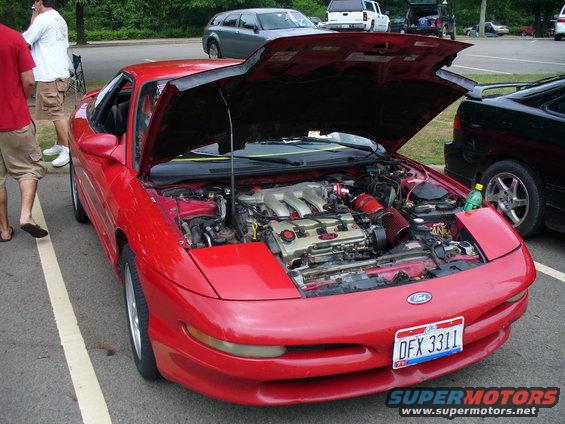 Red 1991 Ford Probe with hood open showing engine. License plate DFX 3311