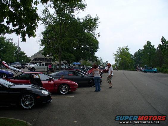 Red 1991 Ford Probe parked in a lot with hoods up