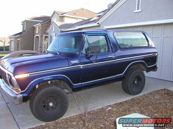 1978 Ford Bronco, blue, parked in driveway next to garage