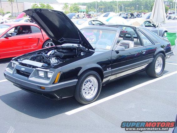 Black 1986 Ford Mustang GT with hood open, showing 5.0 badge