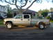 2002 Chevrolet Silverado 2500 - A silver 2002 Chevrolet Silverado 2500 pickup truck is parked on a residential street.