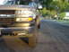 2002 Chevrolet Silverado 2500 - A tan 2002 Chevrolet Silverado 2500 is parked on a residential street, viewed from the front quarter angle.
