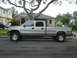 2002 Chevrolet Silverado 2500 - Side view of a silver 2002 Chevrolet Silverado 2500 pickup truck parked on a residential street.