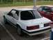 1991 Ford Mustang - Rear view of a white 1991 Ford Mustang coupe, parked outdoors.