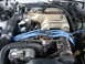 1991 Ford Mustang - Close-up view of a vehicle's engine bay, a 5.0 liter Cobra intake manifold and blue spark plug wires.