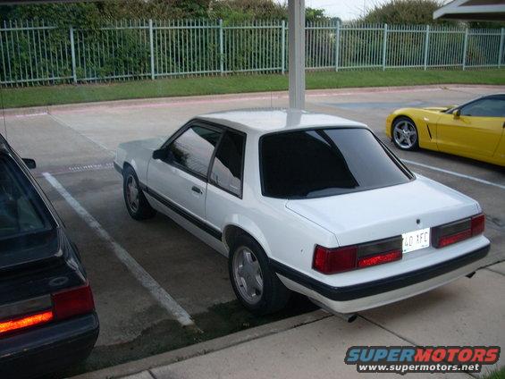White 1991 Ford Mustang coupe, rear view, parked in a lot