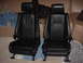 1989 BMW 3 Series - Two black leather car seats, likely from a BMW 3 Series, are shown indoors. The registry claims they are from a 1989 model.