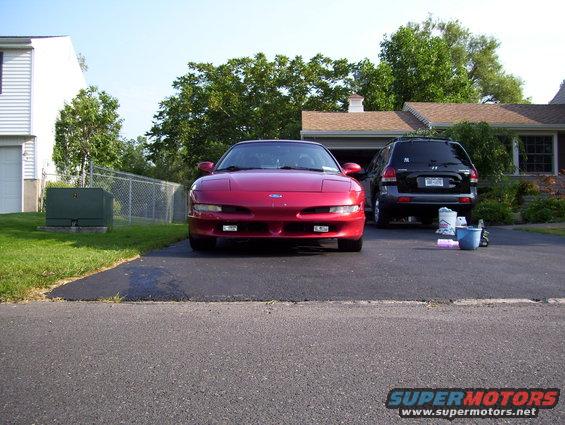 1995 Ford Probe parked in driveway next to a black SUV